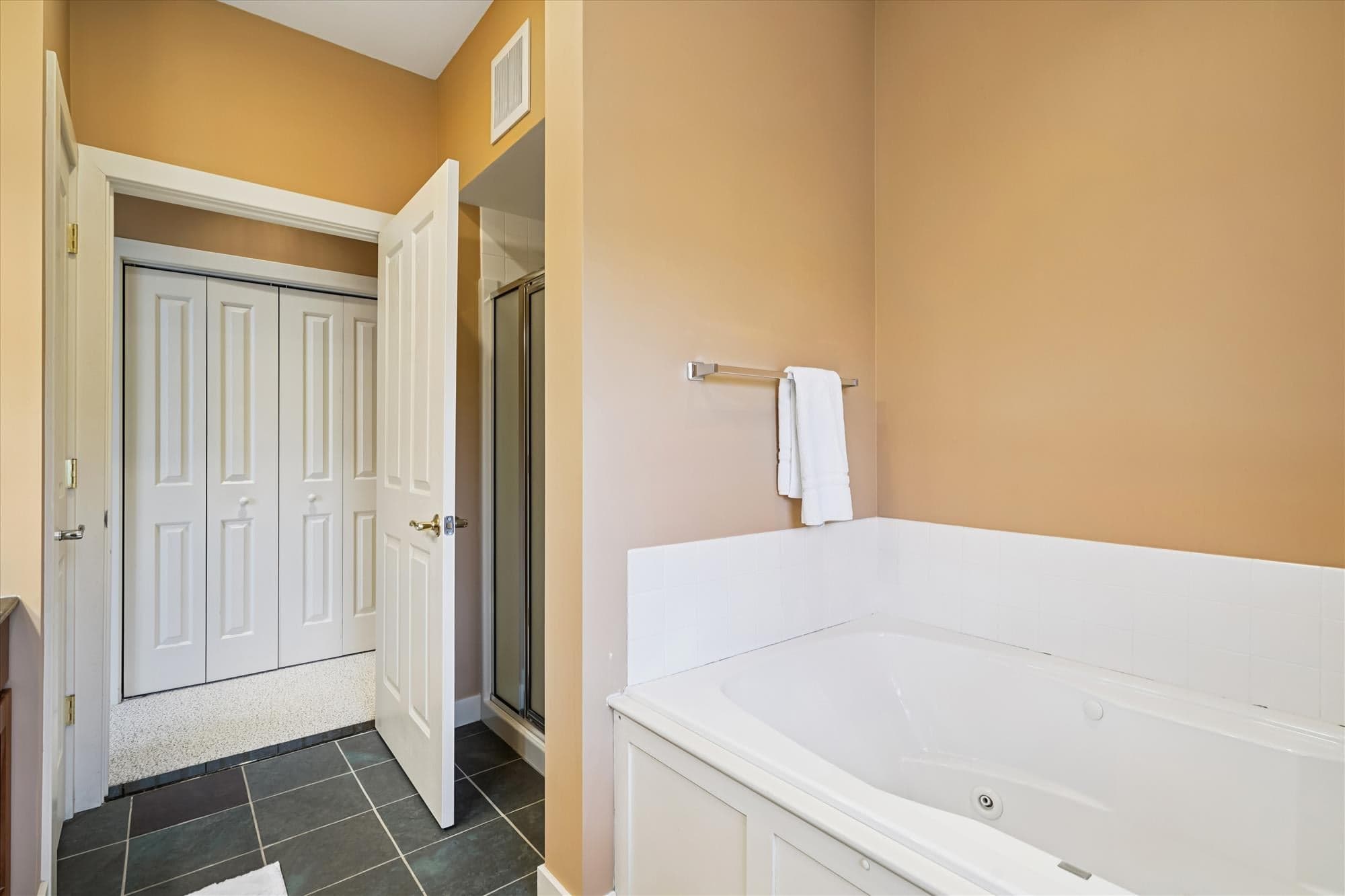 Spacious master bath with double sinks, walk-in shower, and whirlpool tub—perfect for relaxing after time on the mountain.