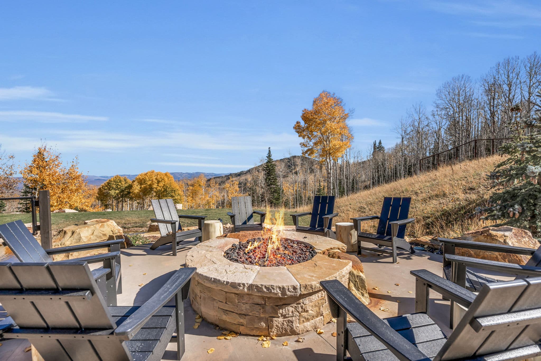 Fire Pit Surrounded by Wooden Outdoor Chairs