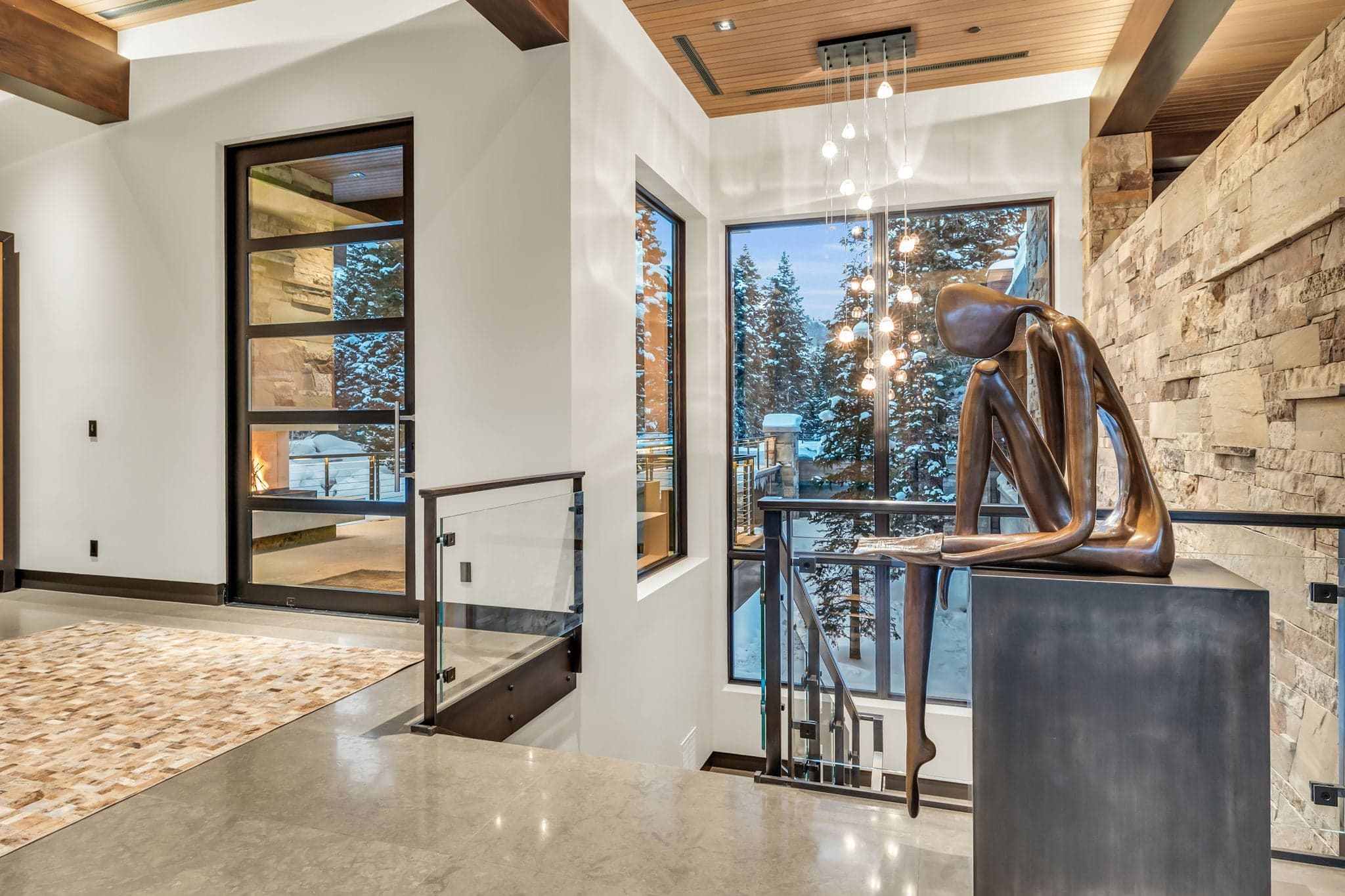 A stylish entryway with modern art and snowy views.
