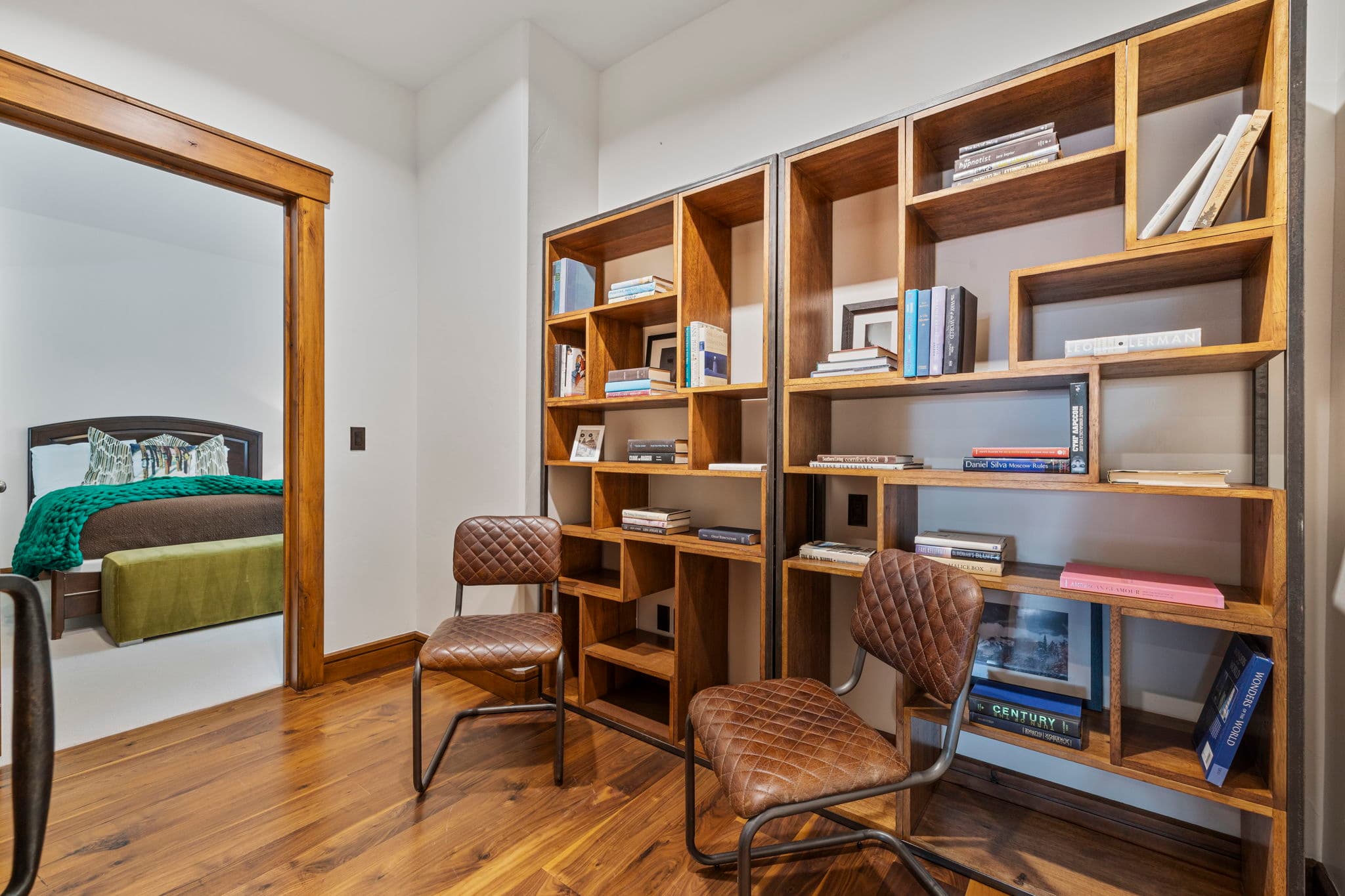 reading nook with cozy seating and lots of books on wall shelves