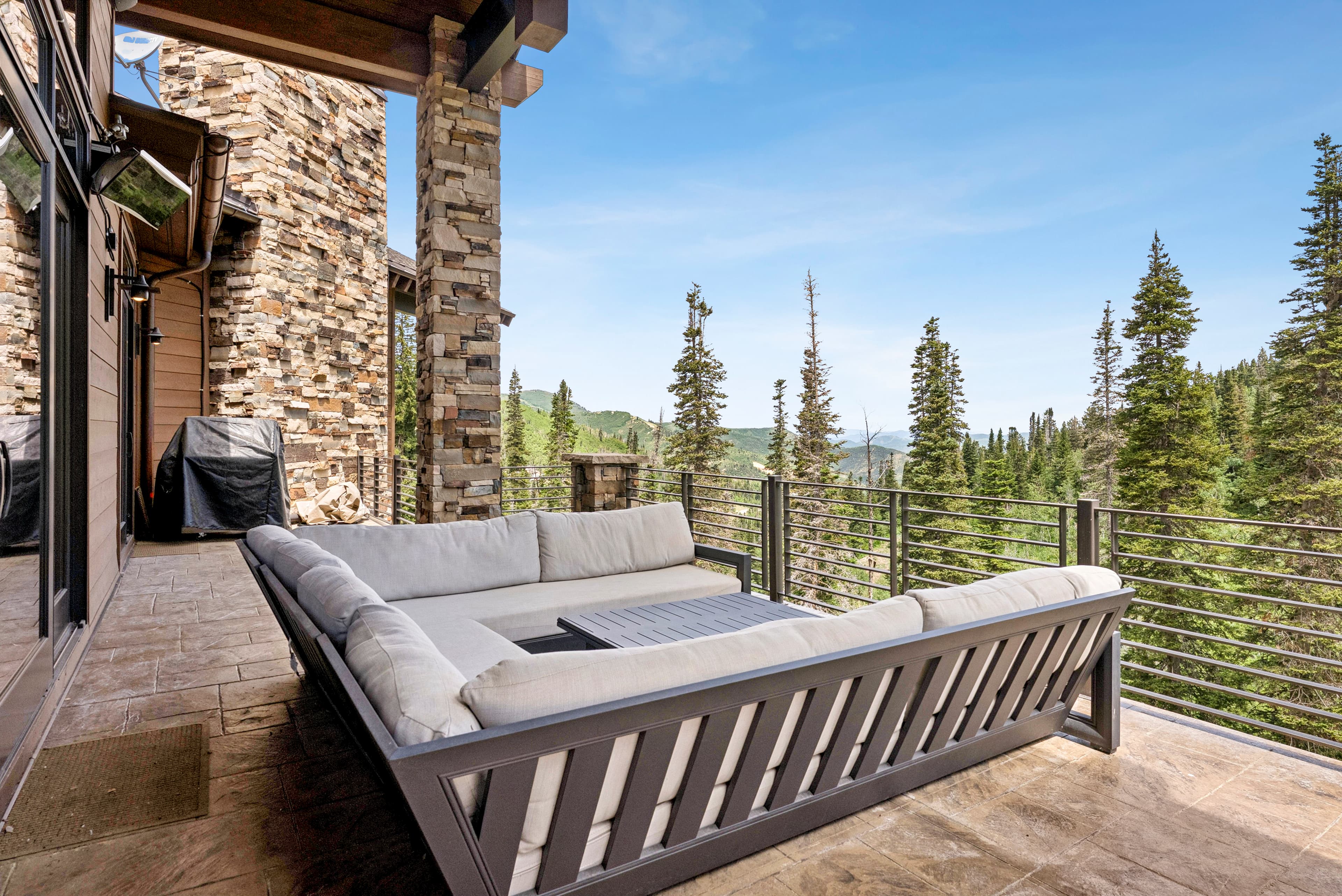 outdoor seating area with overstuffed outdoor lounges and stunning views of the mountains and ski runs